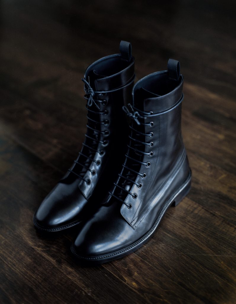 A pair of black leather Unknown Articles boots 