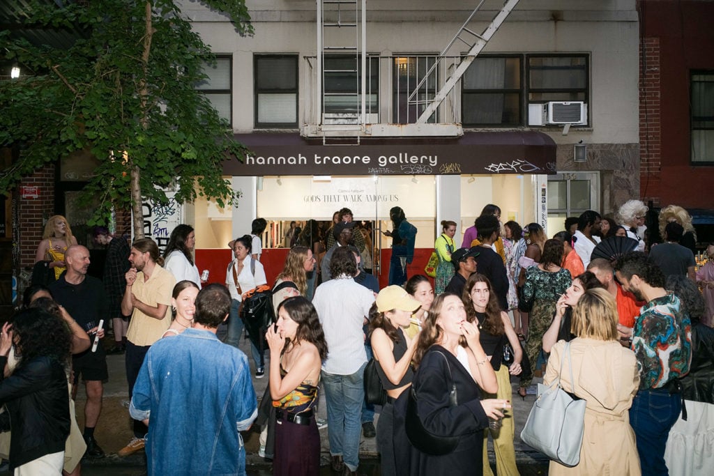 A photo of Hannah Traore's gallery in NYC after a recent opening with people in the street 