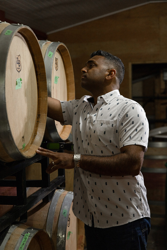 A photo of Karl Coutinho with a barrel of wine 
