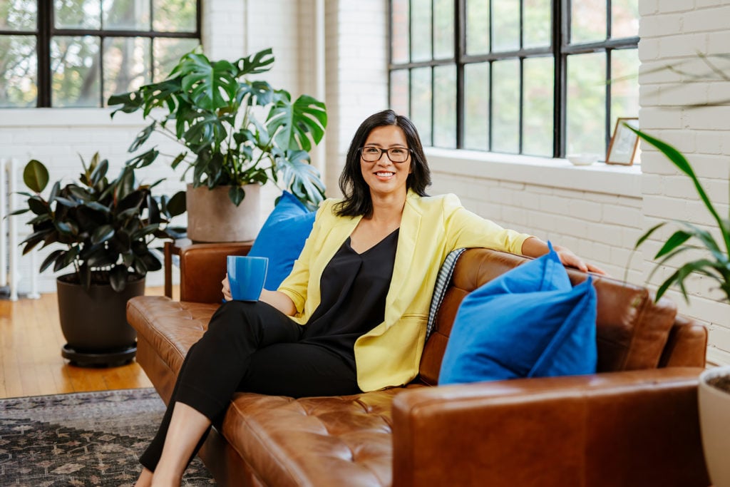 a photograph of Faye Pang, Xero's Canadian country manager, sitting on a leather sofa 