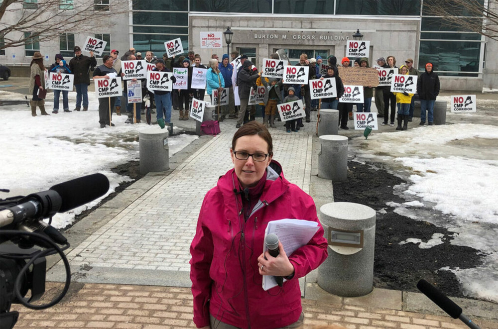 A photo of Sandra Howard, leader of the Say NO to NECEC group opposed to Central Maine Power’s proposed transmission line, speaks to reporters as protestors rally outside the State House in Augusta on Friday, March 15, 2019 