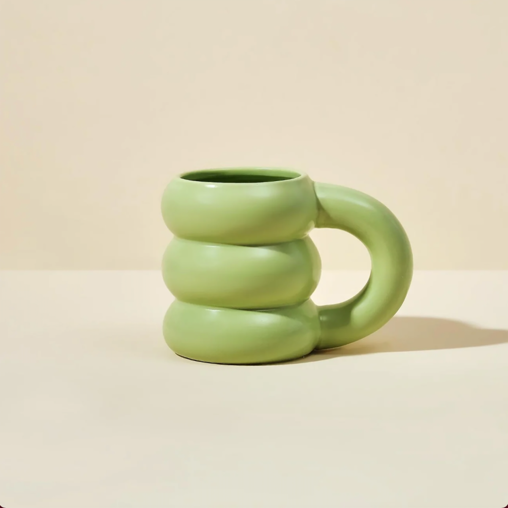 A photo of a green Blume mug
